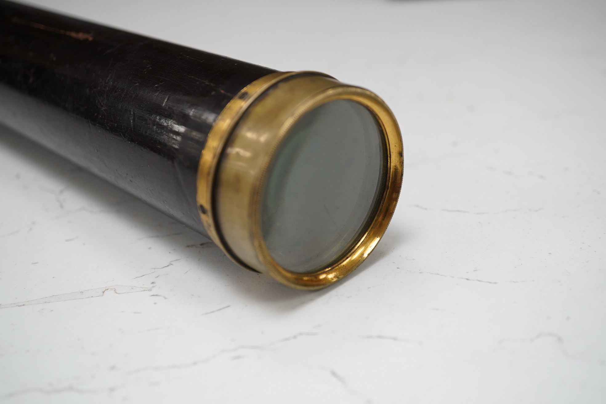 A leather cased Dolland three draw telescope, 72cm fully drawn. Condition - fair considering use